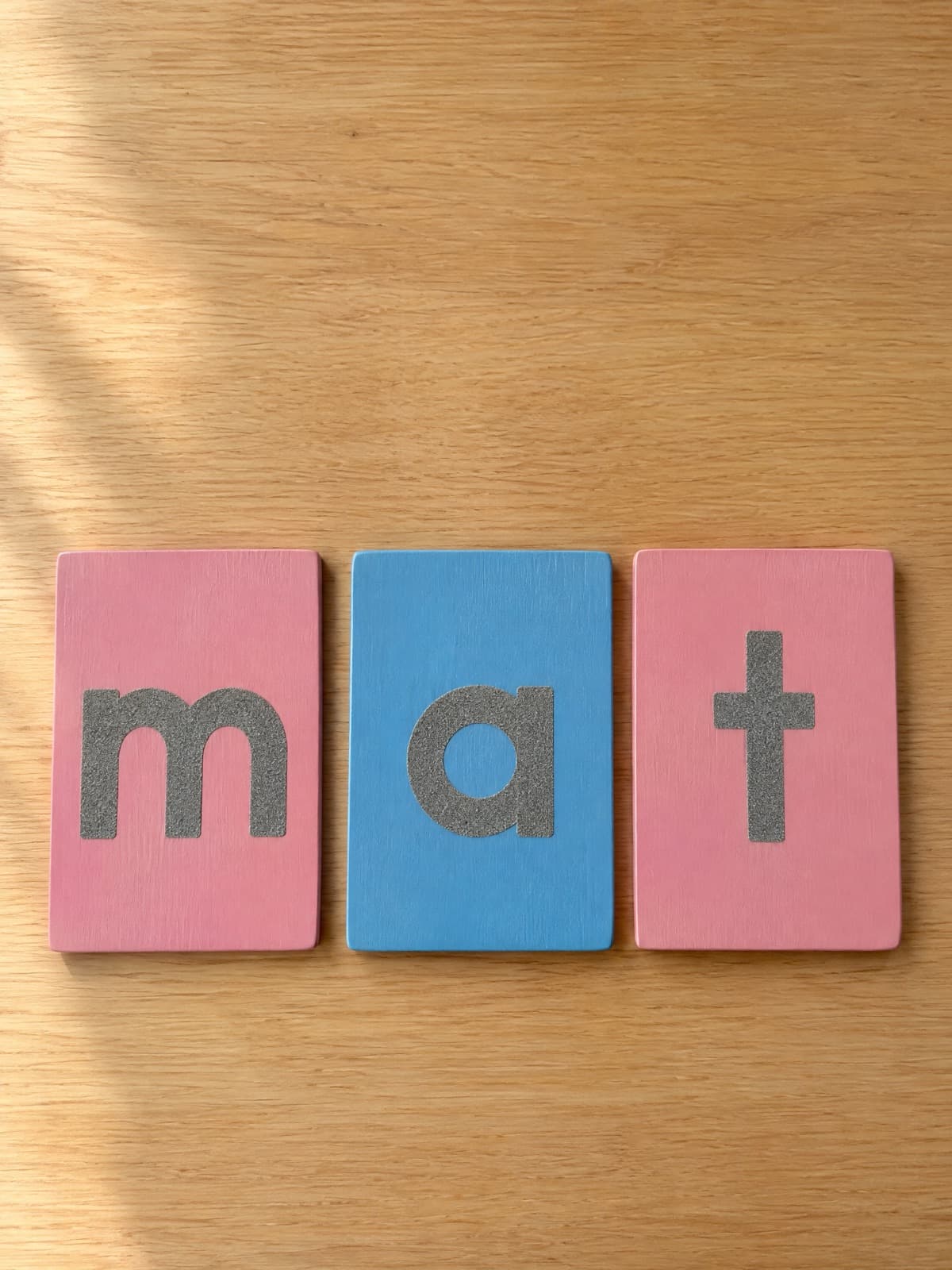 Montessori sandpaper letters on pink and blue boards