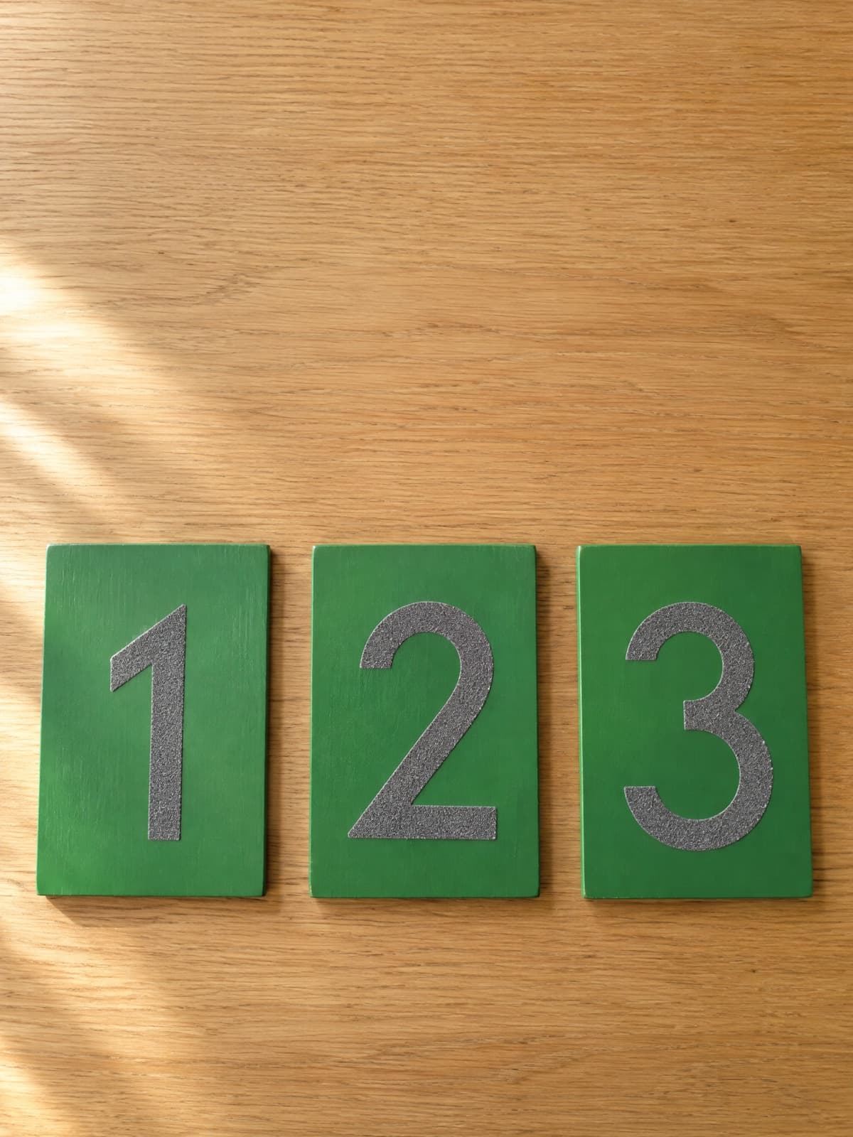 Montessori sandpaper numerals 1, 2 and 3 on green boards